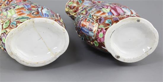 A pair of Chinese famille rose Mandarin vases and covers, Qianlong period, 35.5cm, some restorations